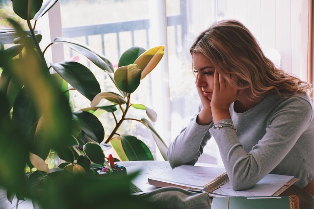 Student working from home during the pandemic, frustrated about all the changes.